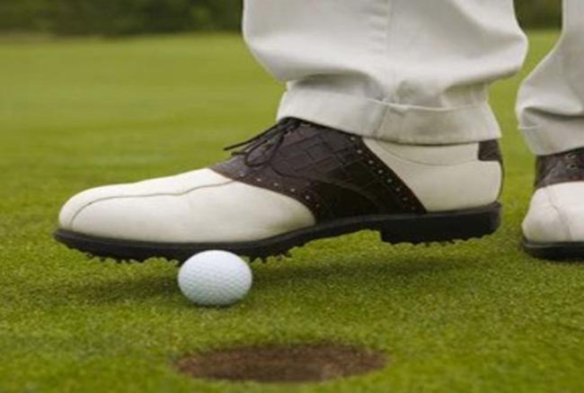 BALL STRIKES THE FLAGSTICK ATTENDANT  